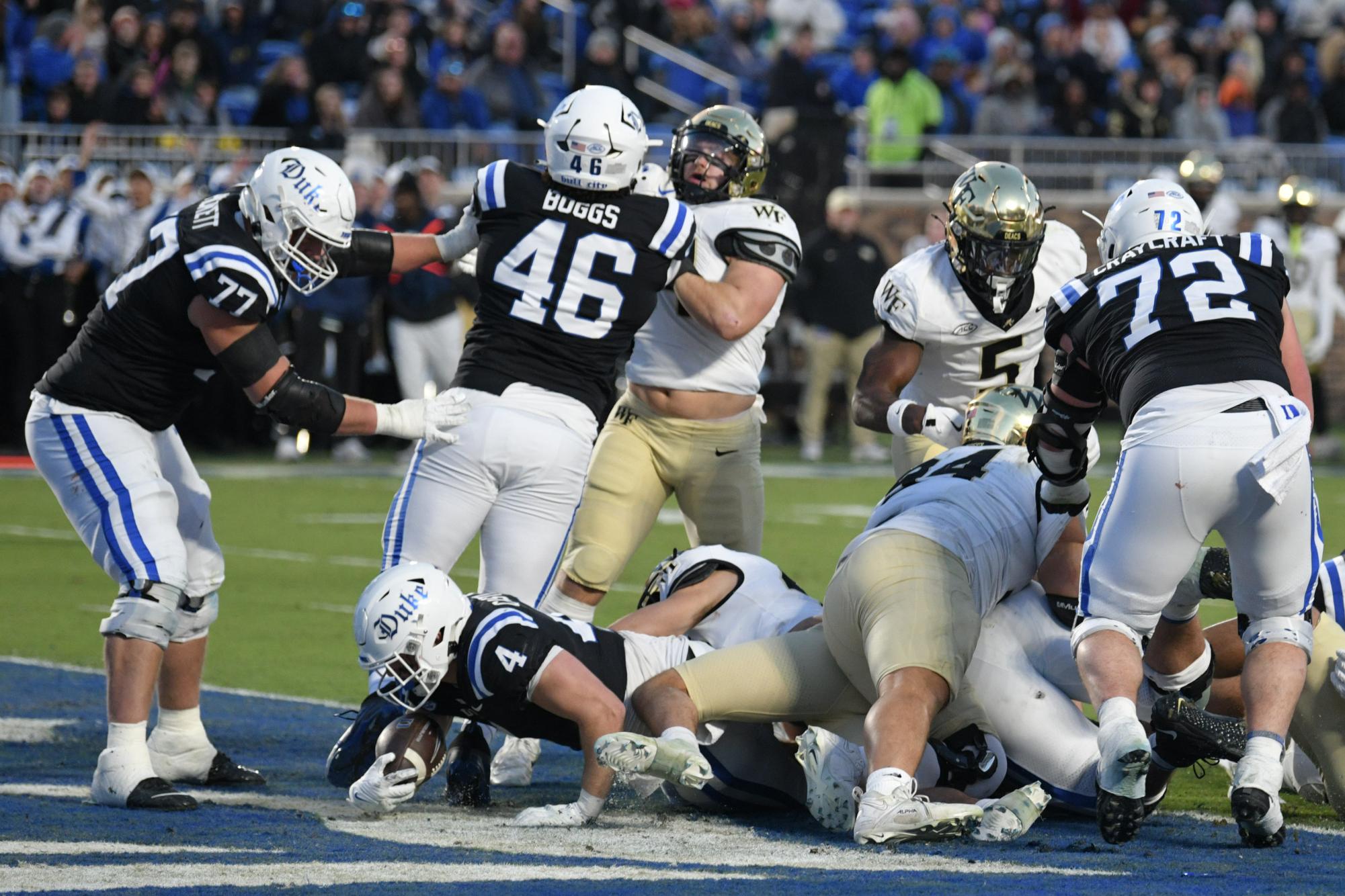 Nov 29, 2025; Durham, North Carolina, USA;  Duke Blue Devils running back Anderson Castle (4) scores a touchdown against the Wake Forest Demon Deacons during the second quarter at Wallace Wade Stadium. Mandatory Credit: Zachary Taft-Imagn Images