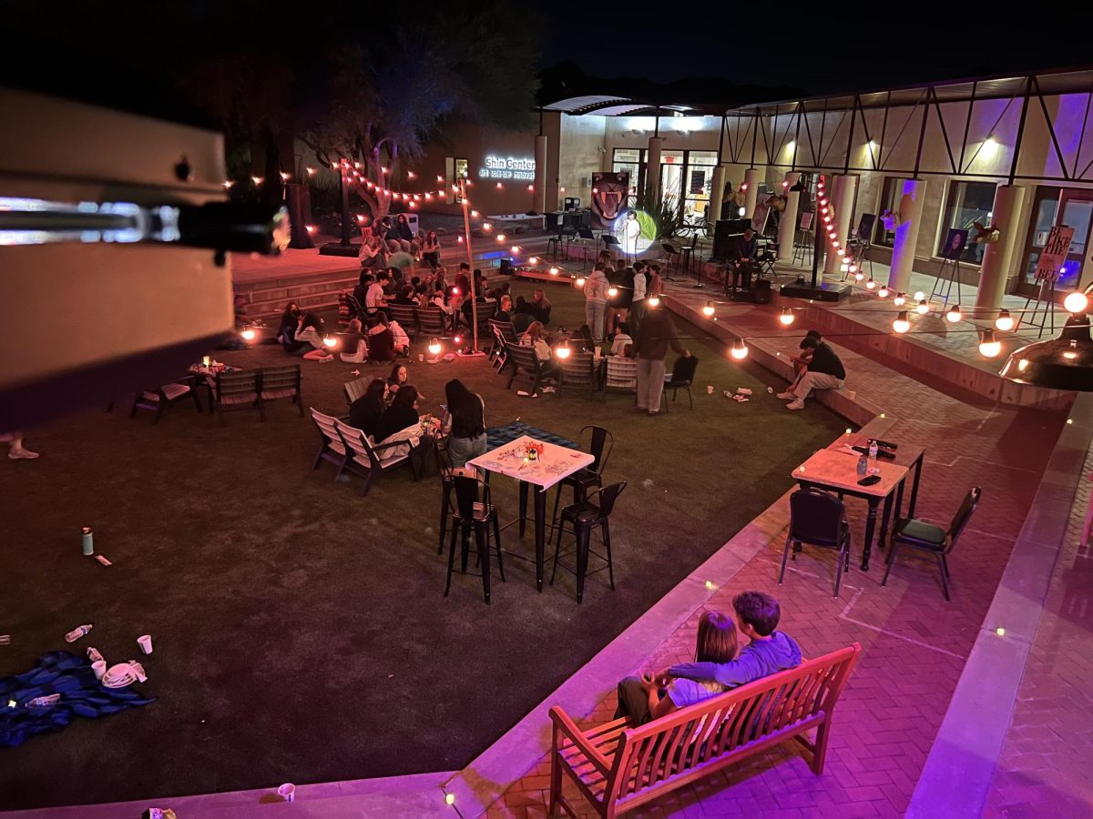 A student performs in Noyes Courtyard during Coffee House