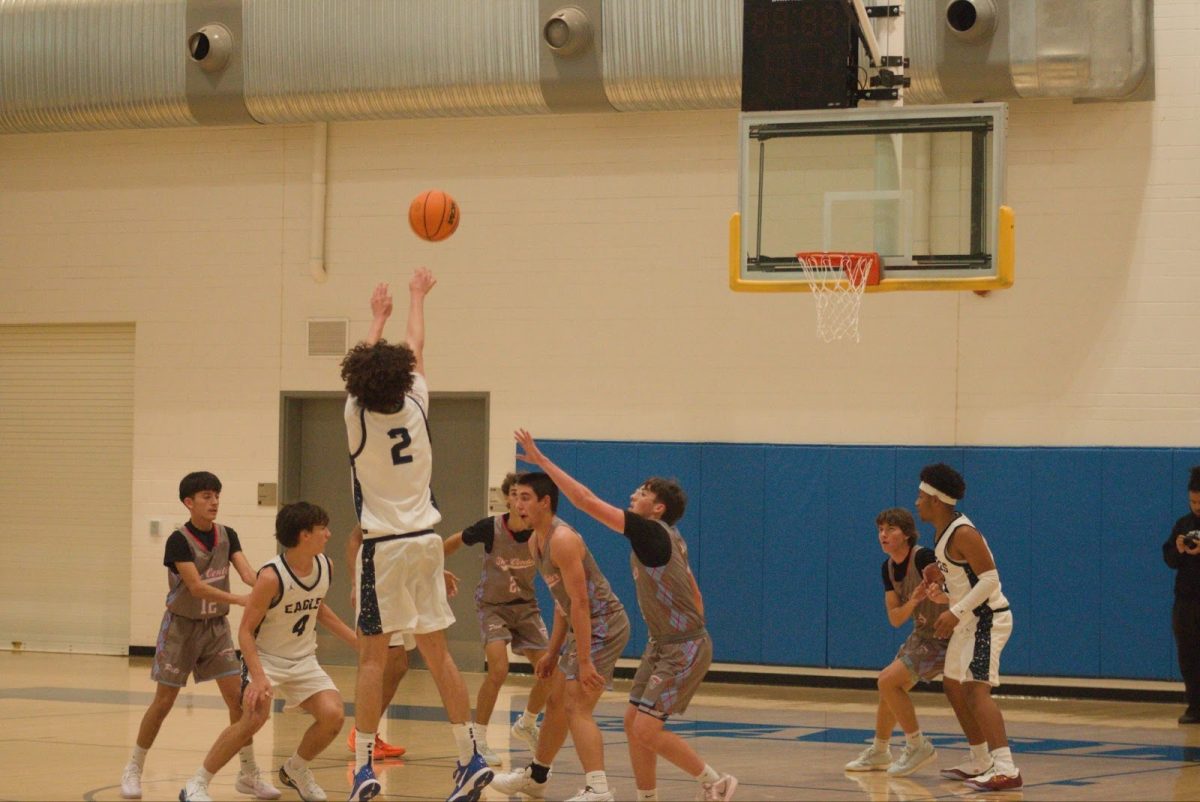 Junior Jadd Agha shooting a three-pointer