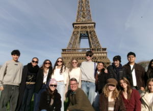 Students pose in front of the Eiffel Tower
